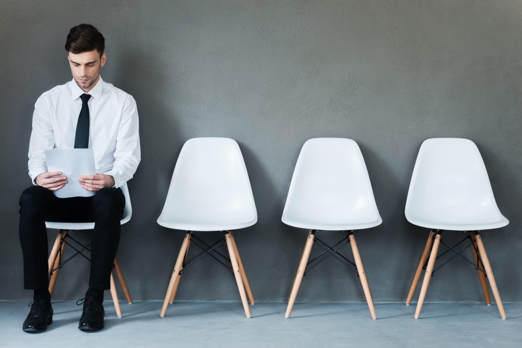 Man Sitting Looking at Phone