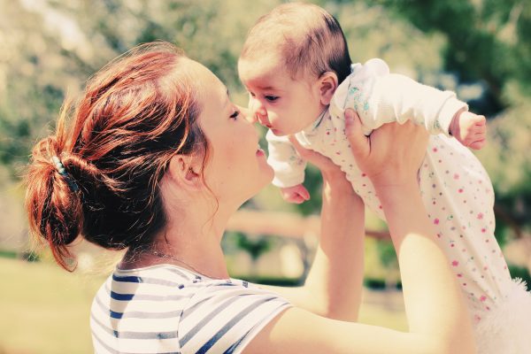 Mom lifting baby