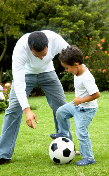 father and son playing soccer